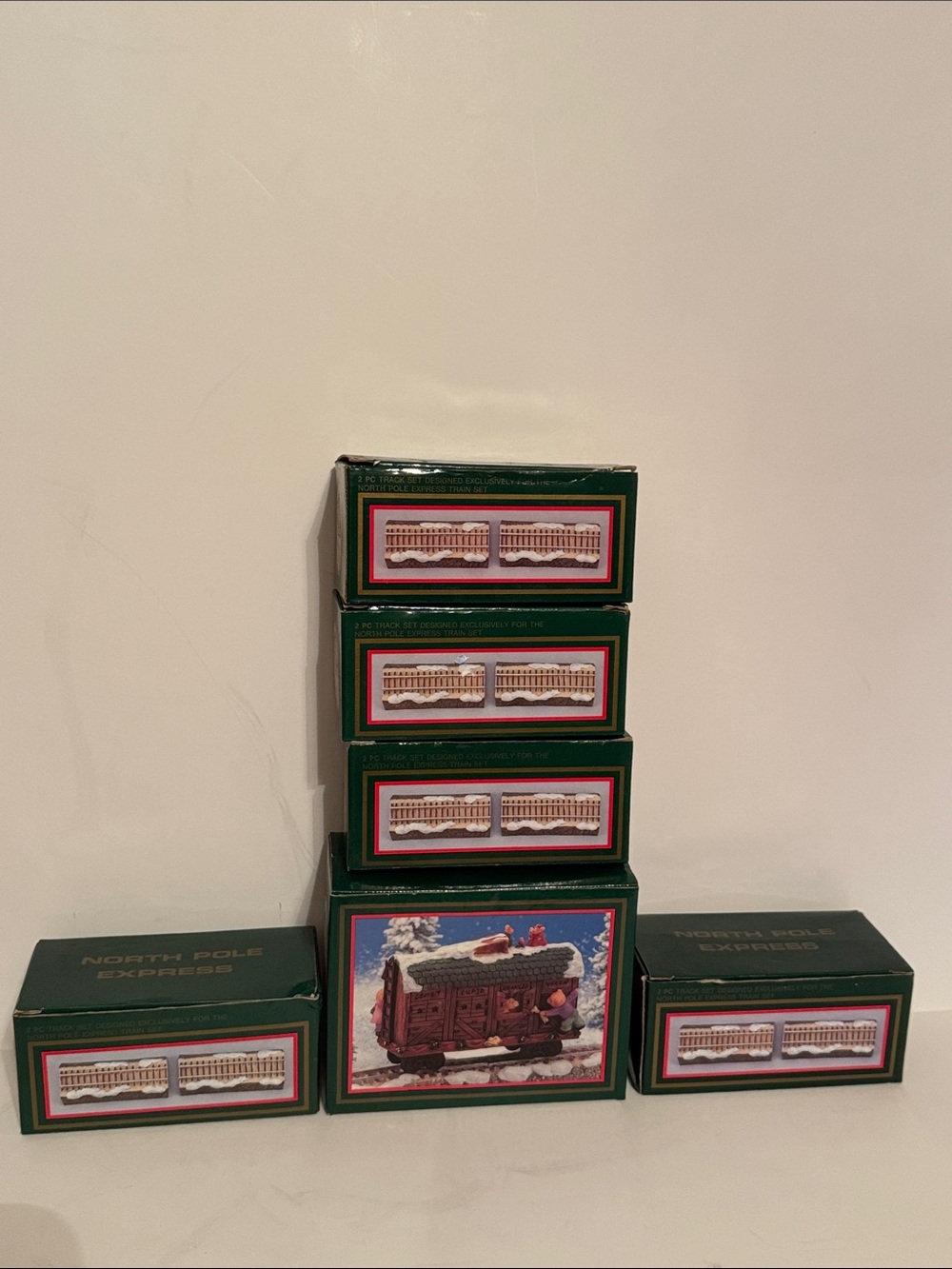 Vintage North Pole Express train car and 5 boxes of 2 rail tracks.